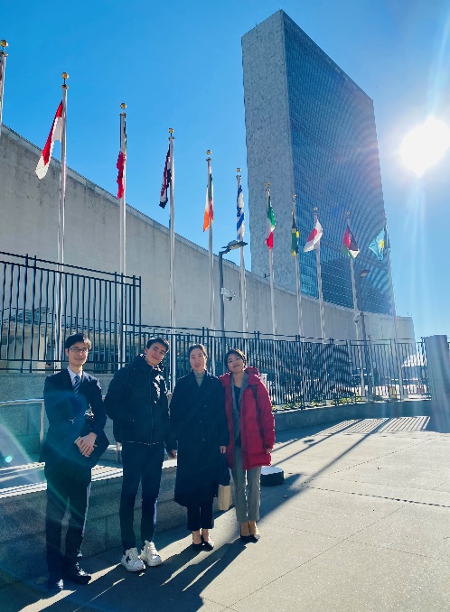 A group of people standing outside of a buildingDescription automatically generated
