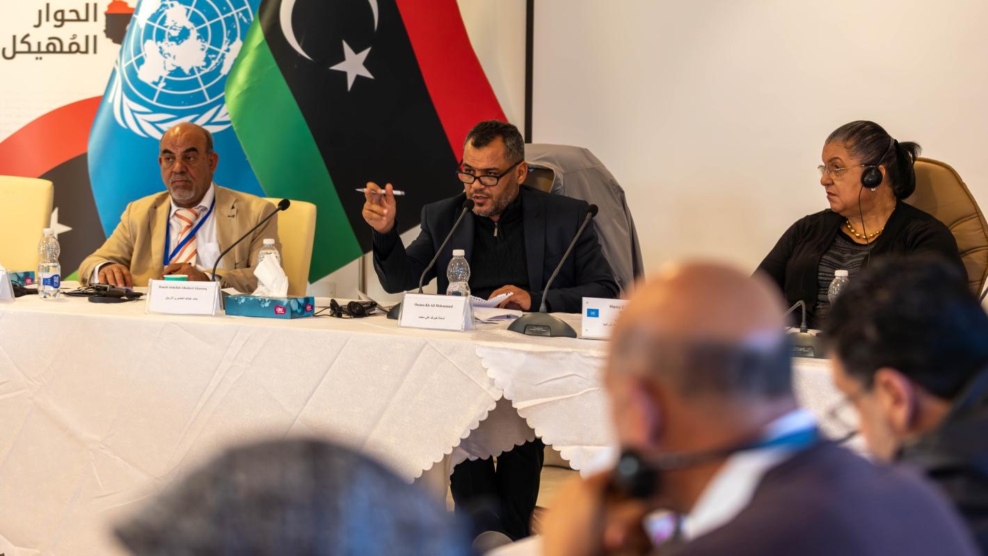 Two bureau members of the Governance Track of the Structured Dialogue sits at a table with SRSG Hanna Tetteh, leading a discussion