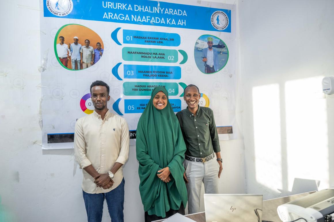 A photo of Abdirahman Mohamud Kulane (left), Abdulkadir Mohamed Abdullahi (right, and Hamdi Hussein Osman (middle), pose for a group photo in Mogadishu, Somalia.