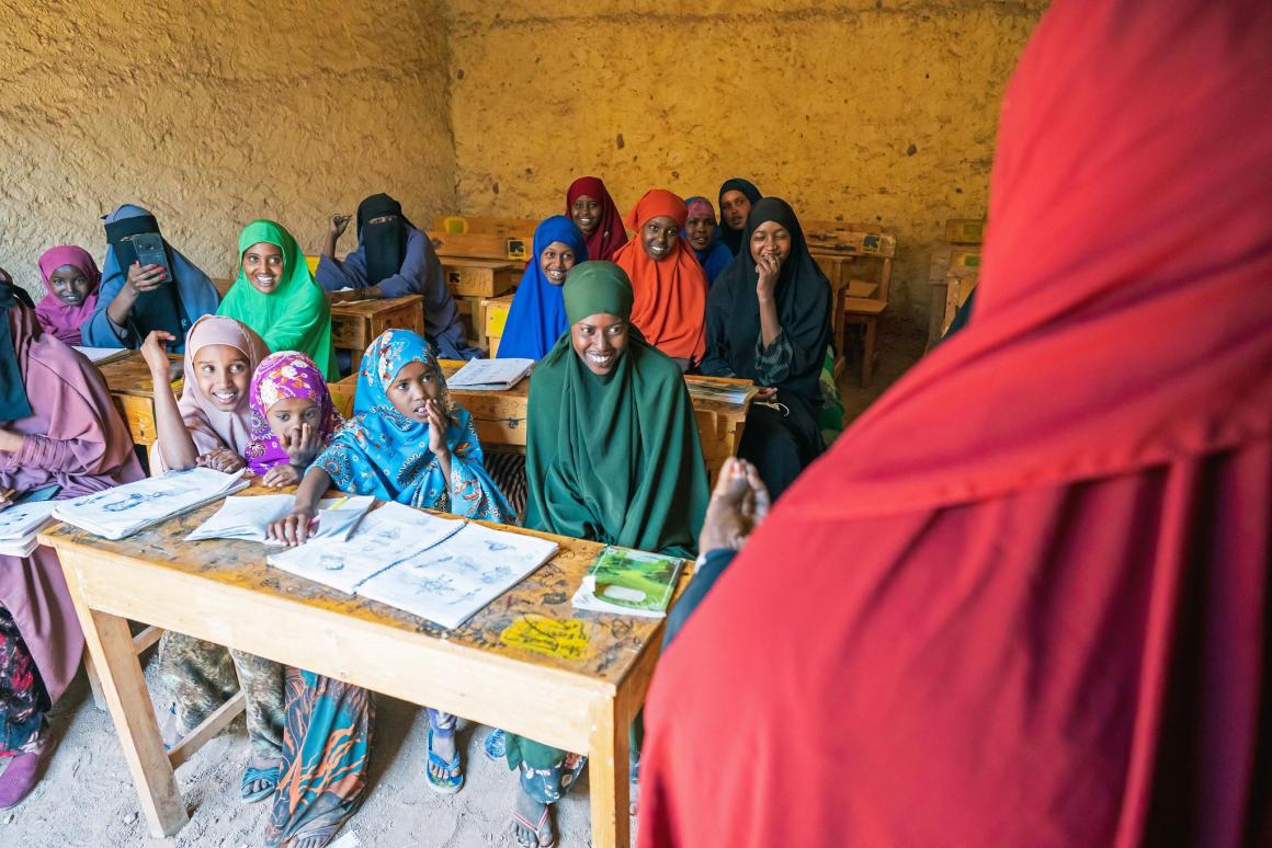 Halimo Mohamud Abdi Gele (in red with back to camera), Director of the Burtinle Women’s Training Centre, teaches women in the classroom at the Centre’s headquarters in Burtinle, Puntland, Somalia, on 20 March 2022